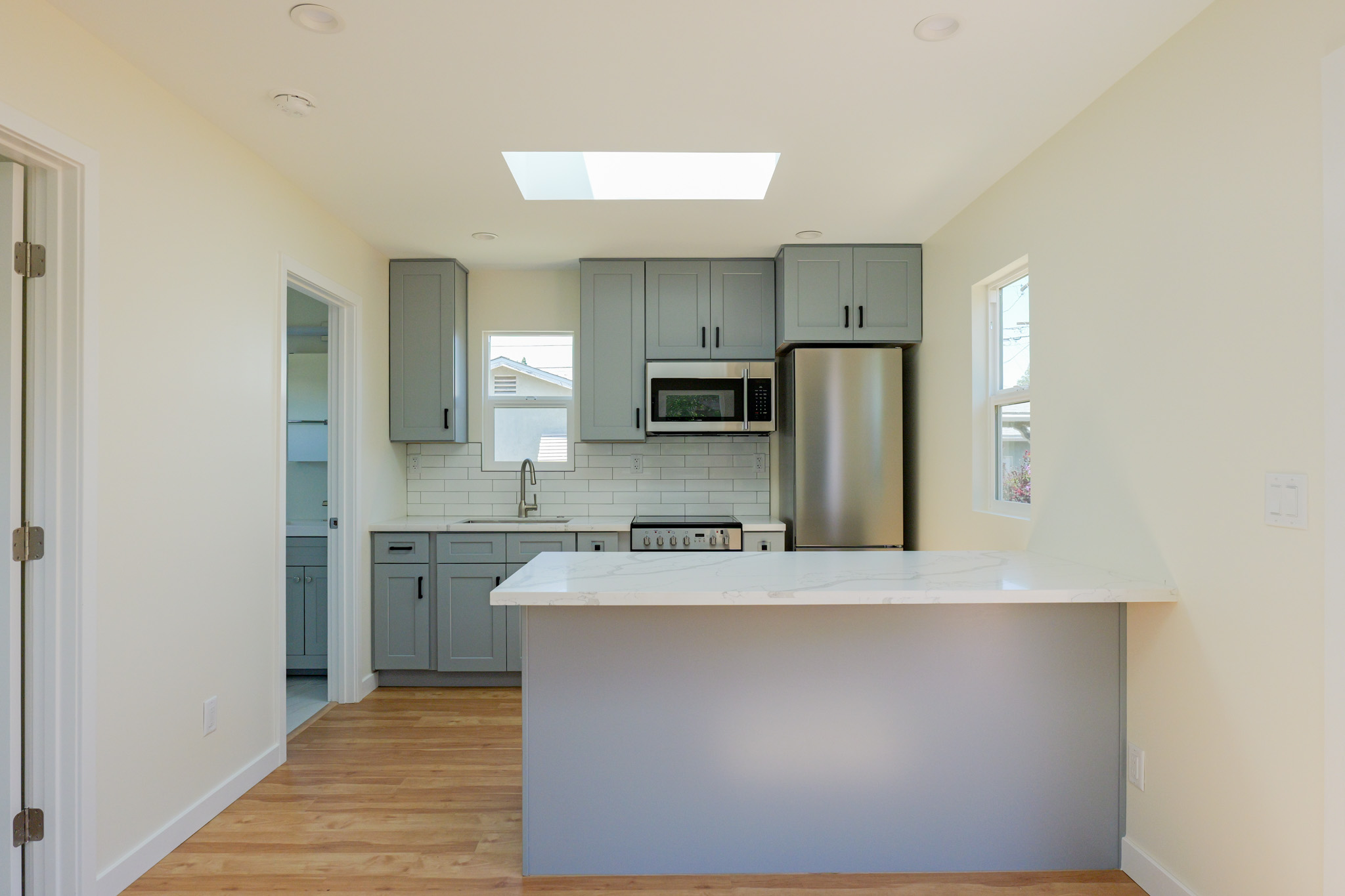 Compact kitchen in the Bocaw ADU with full-size appliances along a single wall.