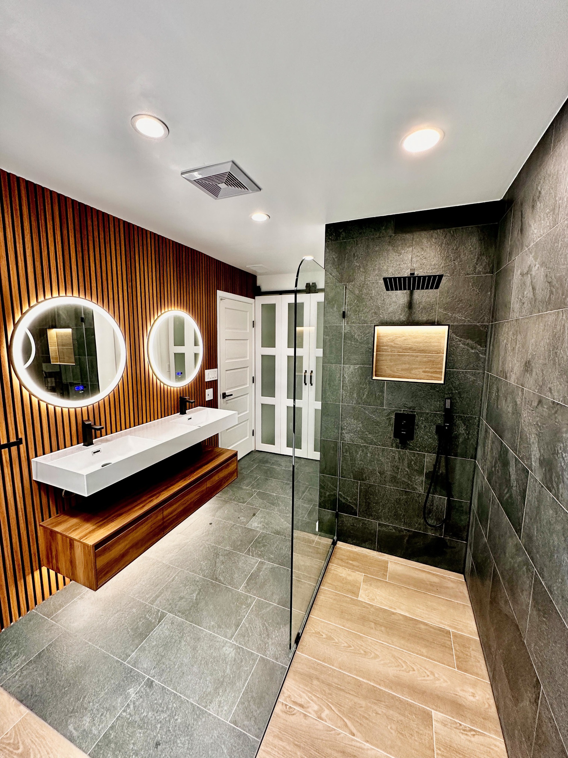 Circular backlit bathroom mirrors in a Saratoga renovation